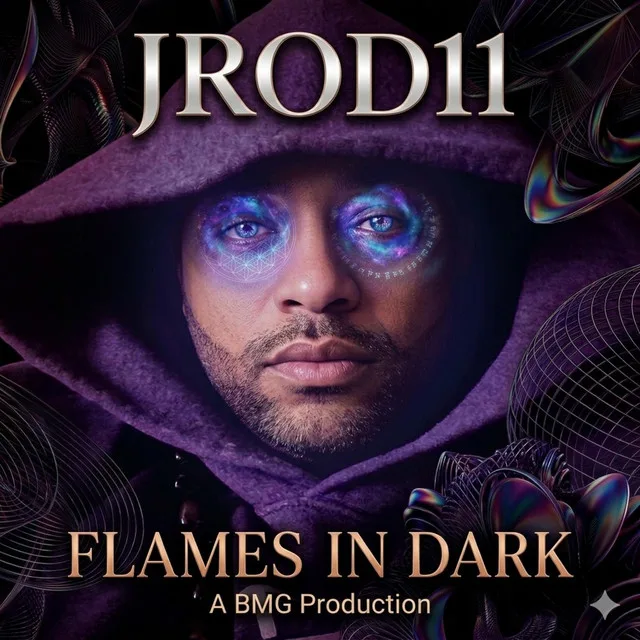 “Flames In The Dark” cover art — JROD11 in a purple hood, cosmic light and sacred geometry glowing across his eyes