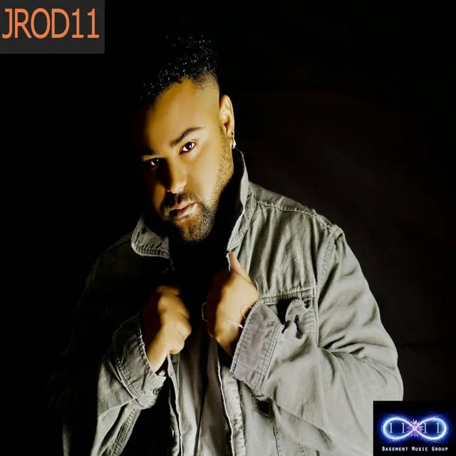 “Stand by Me” cover art — JC in a gray jacket against a black background, adjusting his collar